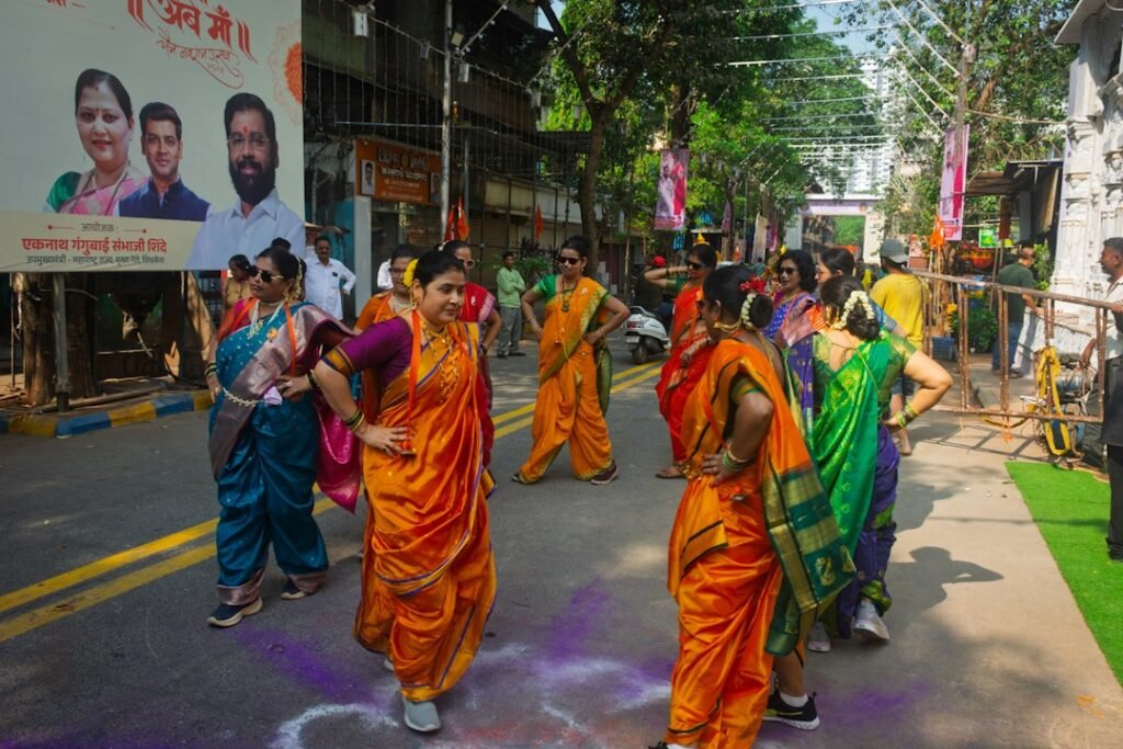 Best Garba Events in Mumbai 2026: Dates, Venues, Tickets & What to Expect 2 Women in colourful saris dancing garba during Navratri